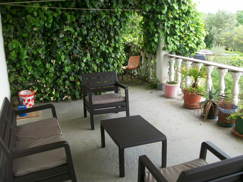 a group of chairs and a table on a patio at Comfortable holiday home in Labin in Drenje