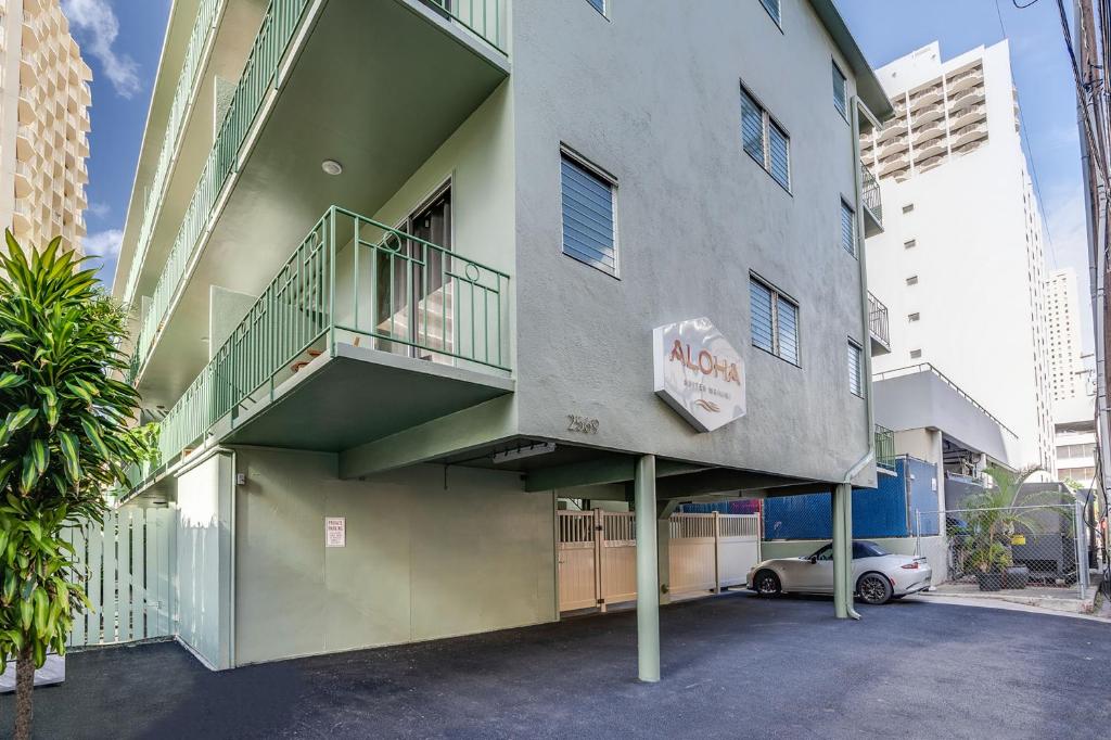 a building with a balcony on the side of it at Aloha Suites Waikiki in Honolulu