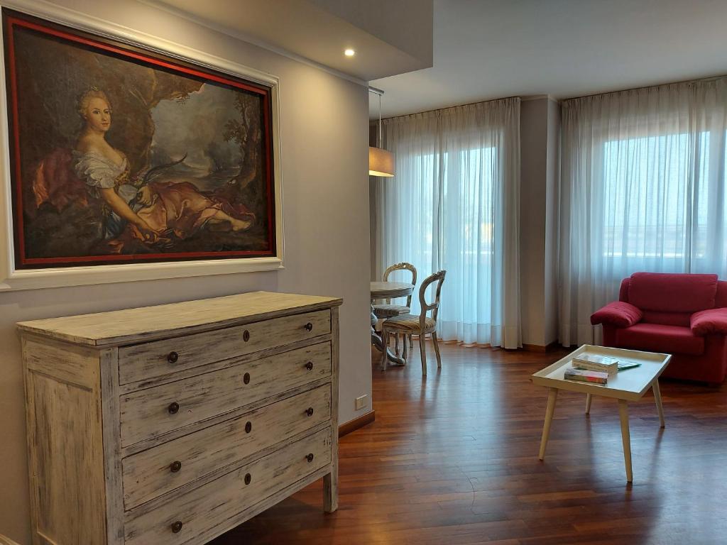 a living room with a painting on the wall at Trilocale Ferruccio in Baveno