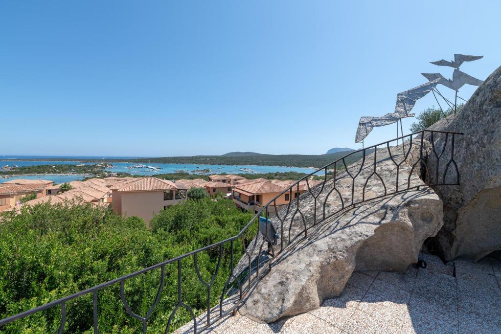 a stairway with a railing on a rock at Baia de Bahas Residence in Golfo Aranci