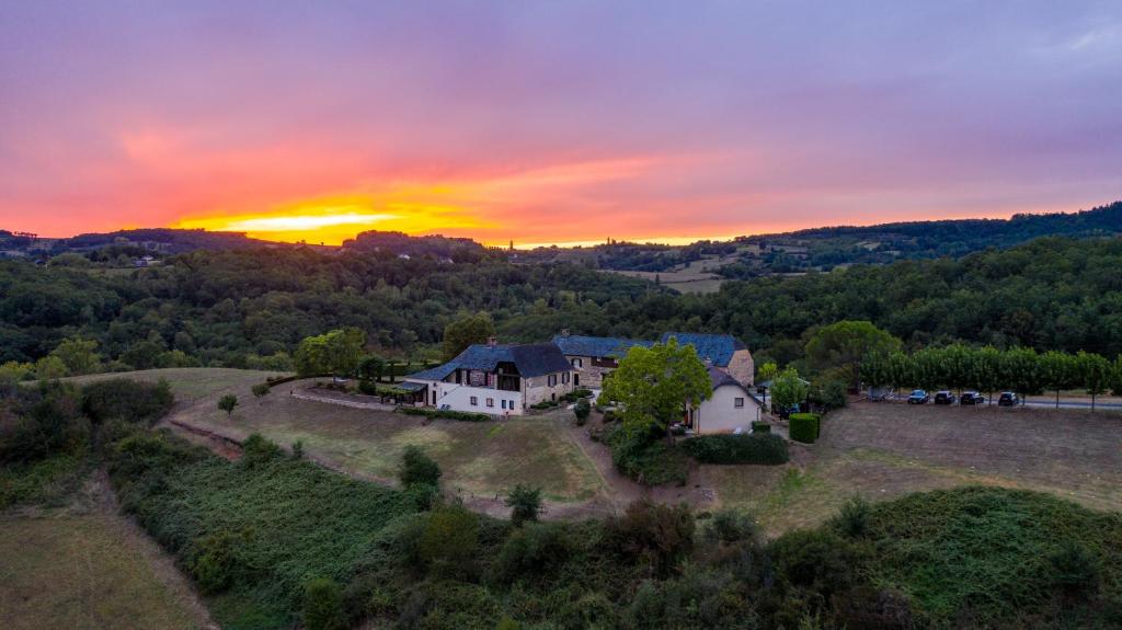 an aerial view of a house with the sunset in the background at Domaine Leyvinie, gite Mourvedre, close to the Dordogne in Perpezac-le-Blanc
