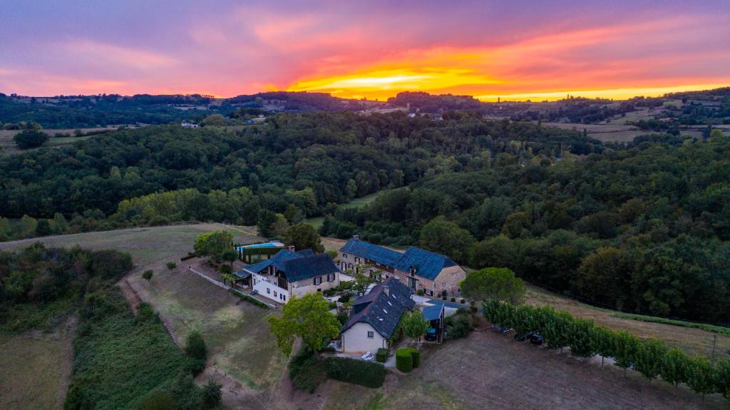 an aerial view of a house with a sunset in the background at Domaine Leyvinie, gite Mourvedre, close to the Dordogne in Perpezac-le-Blanc