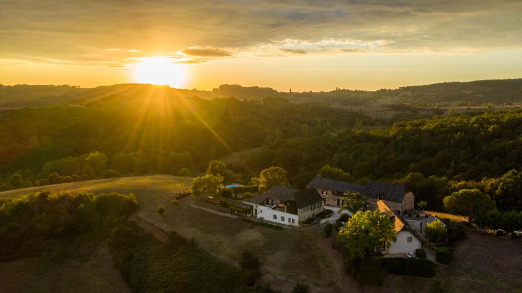 an aerial view of a house with the sunset in the background at Domaine Leyvinie, gite Mourvedre, close to the Dordogne in Perpezac-le-Blanc