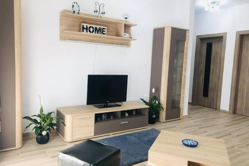 a living room with a flat screen tv on a stand at Bonte Residence str Daliei nr 3 Giroc in Giroc