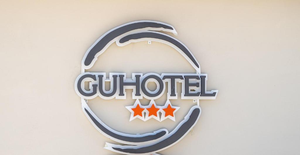 a sign for a club hotel on a wall at Gu Hotel in Guidonia