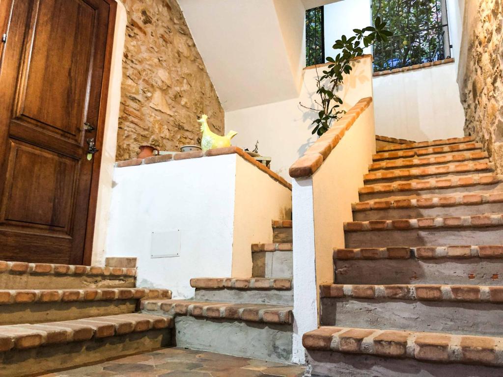 a set of stairs in a house with a door at Sas Tilibbas-Ammentos Posada in Posada