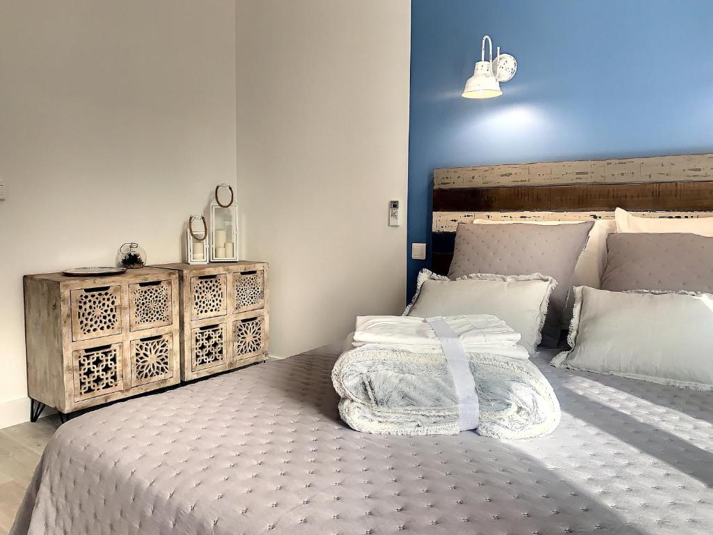 a bedroom with a large bed and a dresser at Horizon Plage in Hyères