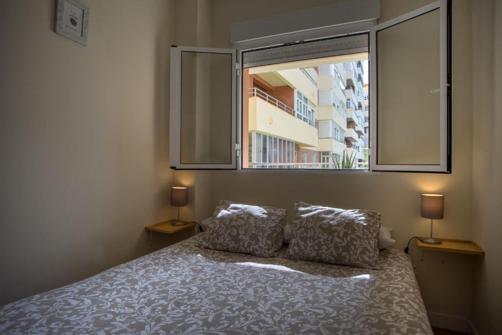 Ліжко або ліжка в номері Sirenas Playa Ha Apartment