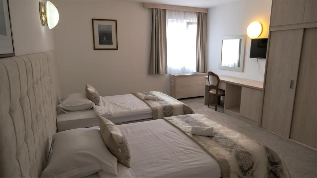 Posteľ alebo postele v izbe v ubytovaní Hotel Consul