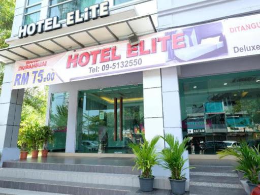 a hotel line with potted plants in front of a building at Elite Hotel in Kuantan