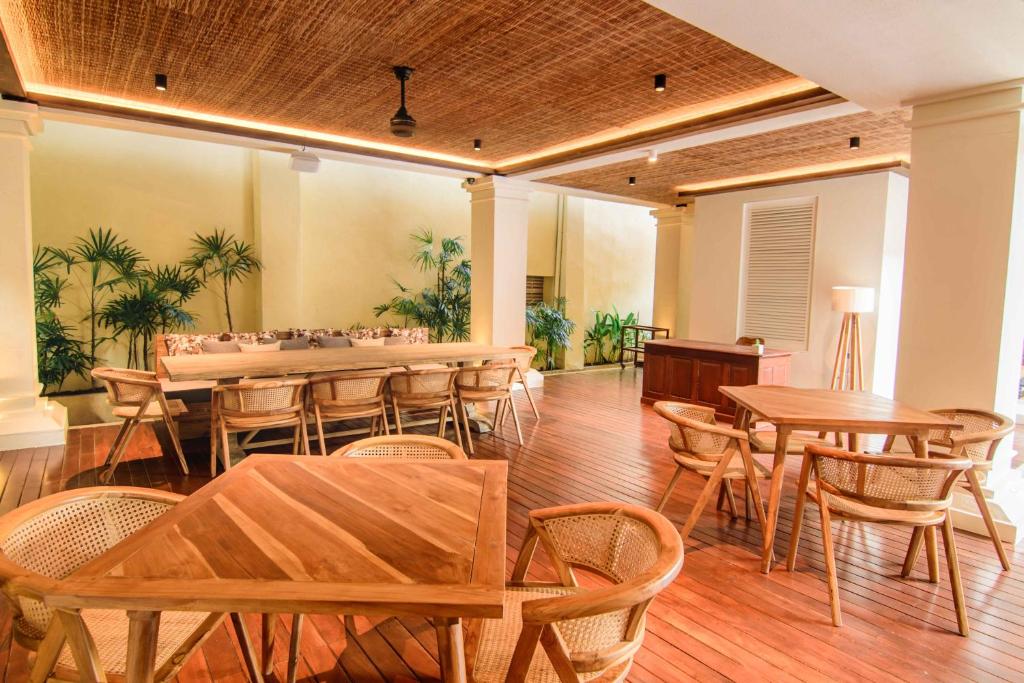 a dining room with wooden tables and chairs at The Merchant in Galle