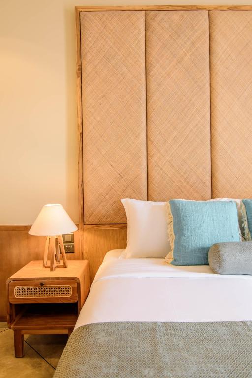 a bedroom with a bed and a lamp on a table at The Merchant in Galle