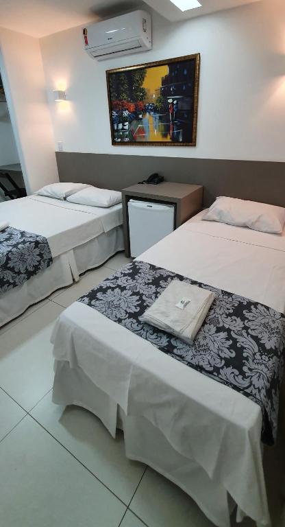 Postel nebo postele na pokoji v ubytování Hotel Hellyus