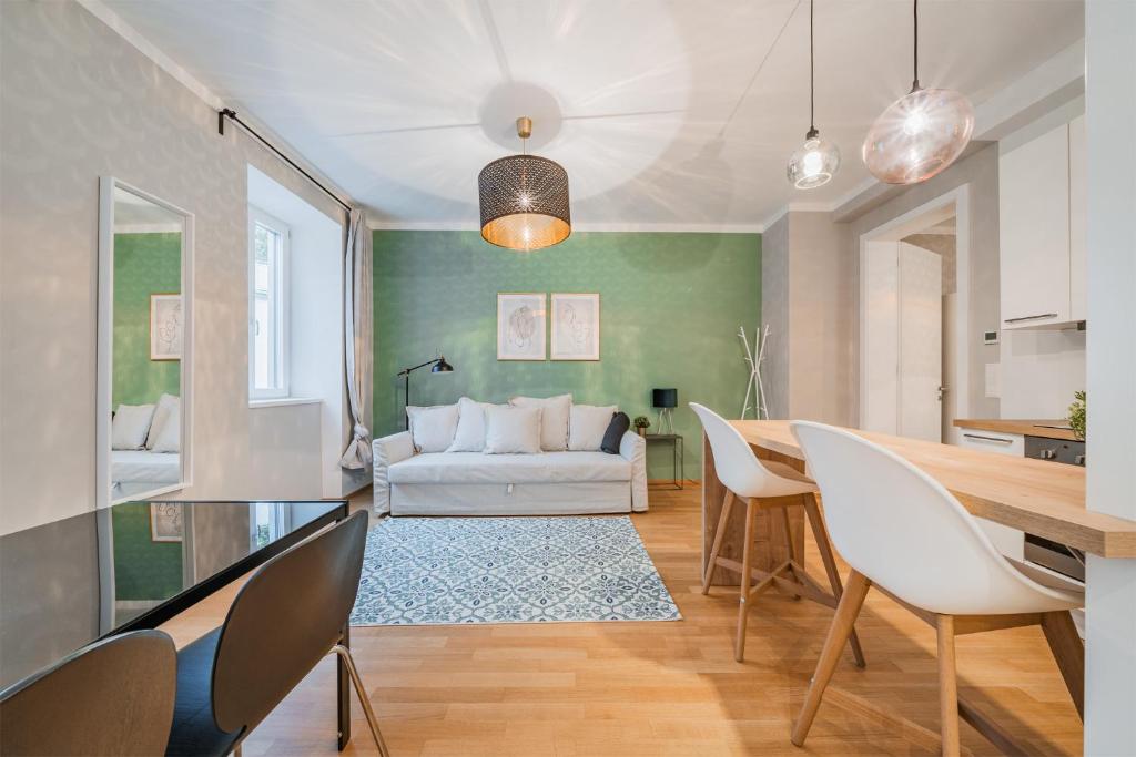 a living room with a table and chairs and a couch at easy flat Molino in Vienna