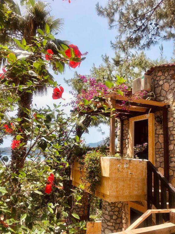 a balcony with flowers on a house at Symbola Oludeniz Beach Hotel in Oludeniz