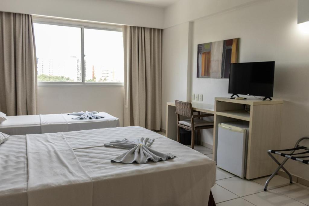 Uma TV ou centro de entretenimento em Apartamento Le Jardin