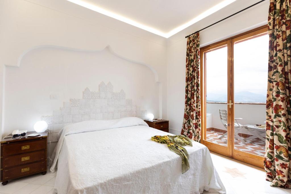 Postel nebo postele na pokoji v ubytování Grand Hotel De Rose