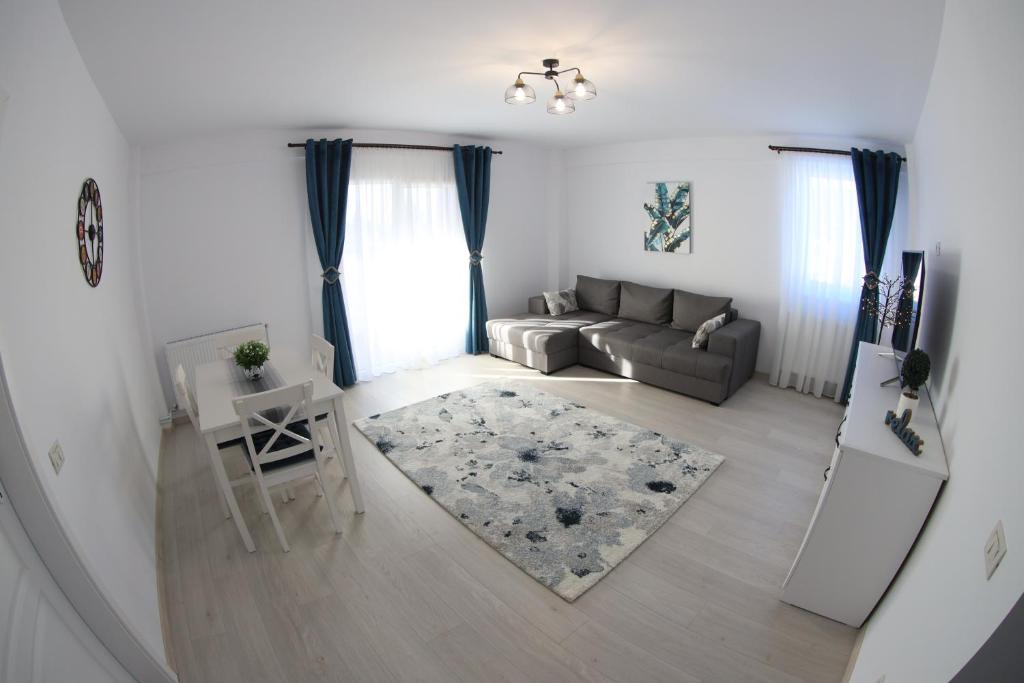 a living room with a couch and a table at White Apartment Gura Humorului, Bucovina, Voronet in Gura Humorului