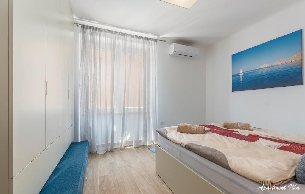 Łóżko lub łóżka w pokoju w obiekcie Apartmani Nena i Ilka