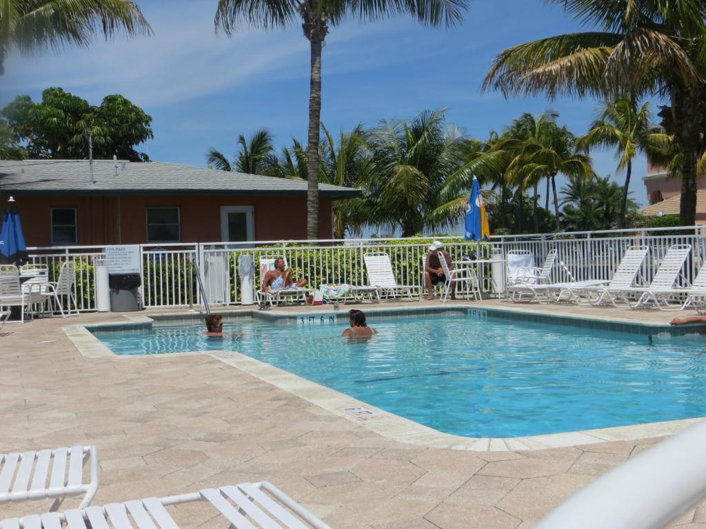 a swimming pool at a resort with people in it at Matanzas Inn in Fort Myers Beach