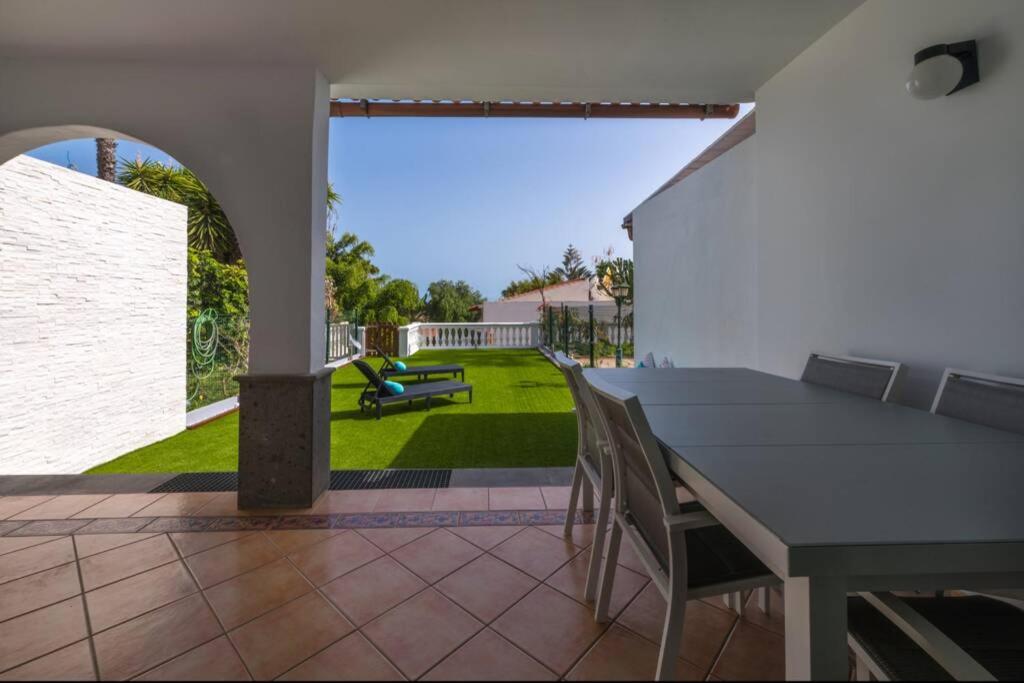 d'une terrasse avec une table, des chaises et une cour. dans l'établissement Dúplex con jardín y buenas vistas, à Maspalomas