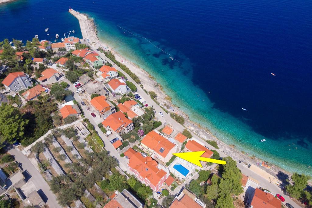 an aerial view of a beach with a yellow arrow at Apartments Andrijic in Prigradica