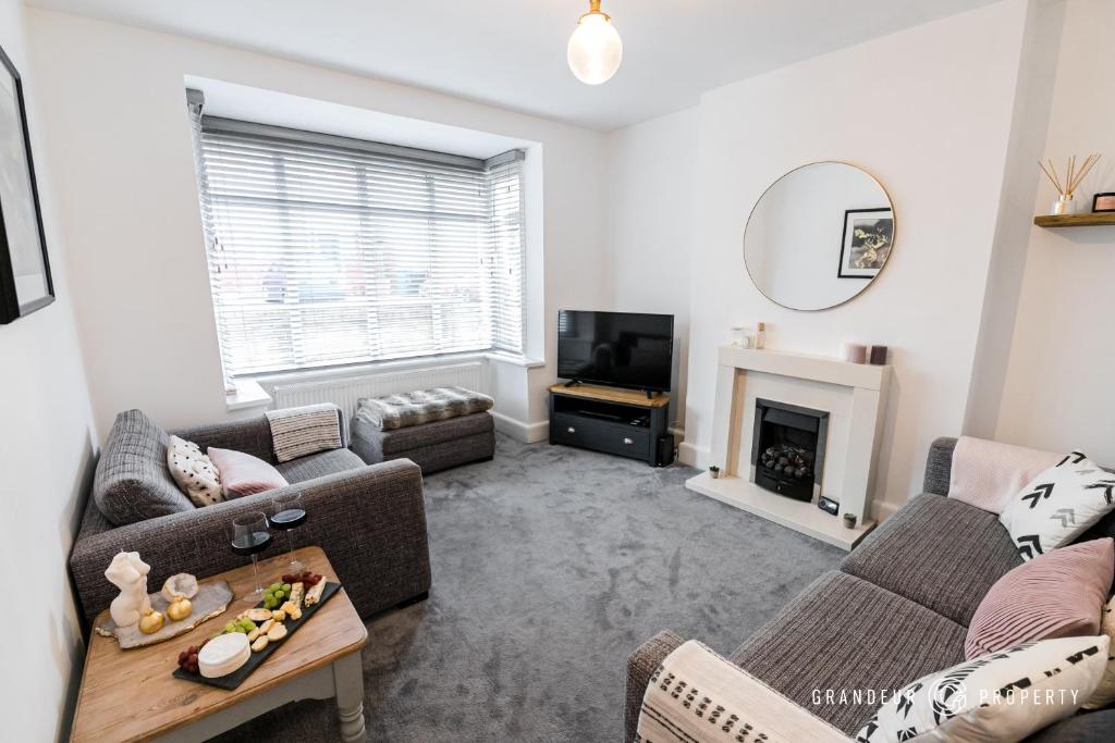 a living room with two couches and a fireplace at Large 2bed House, Heart of Upper Parkstone, Close to Beach - Buckland Heights in Poole