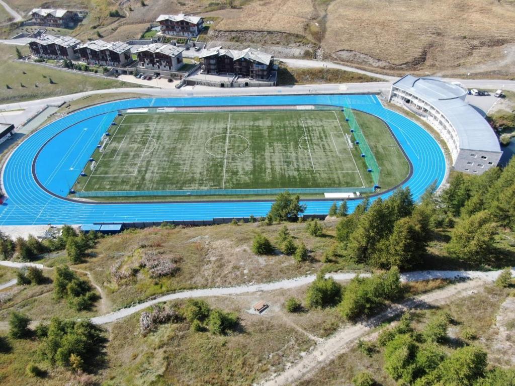 an aerial view of a soccer stadium with a field at Hotel Lago Losetta in Sestriere