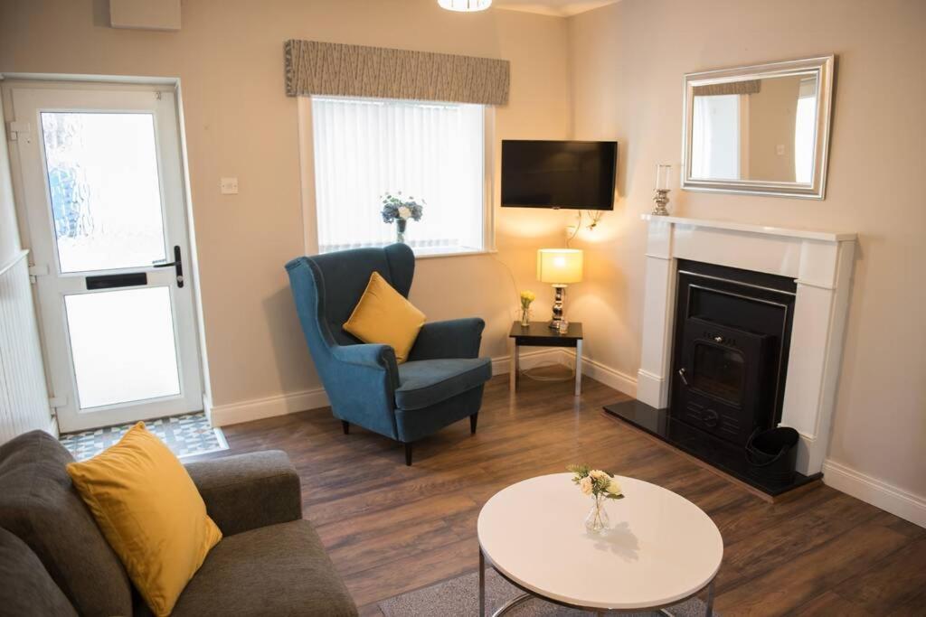 a living room with a couch and a fireplace at The Chalet town centre in Dungloe
