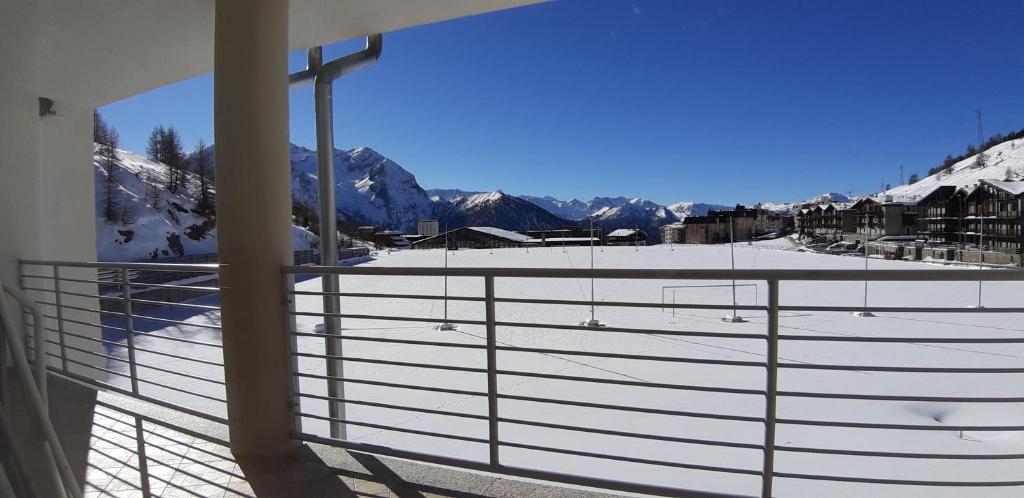 a balcony with a view of a snow covered mountain at Hotel Lago Losetta in Sestriere