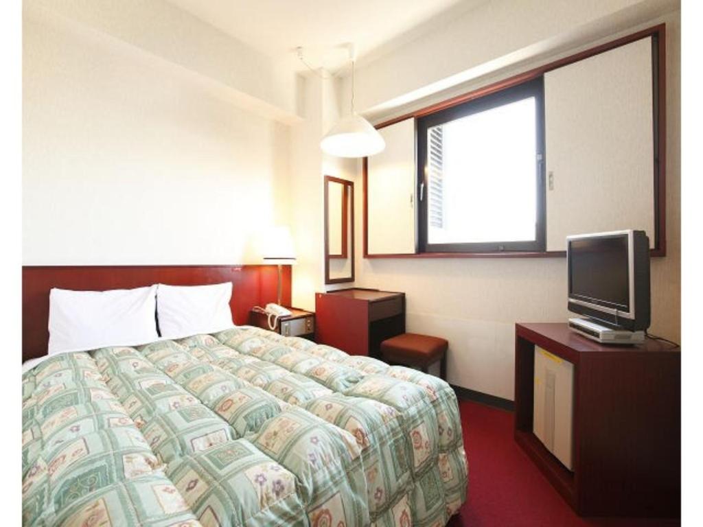 a hotel room with a bed and a tv at Tokyo Inn - Vacation STAY 11102v in Tokyo