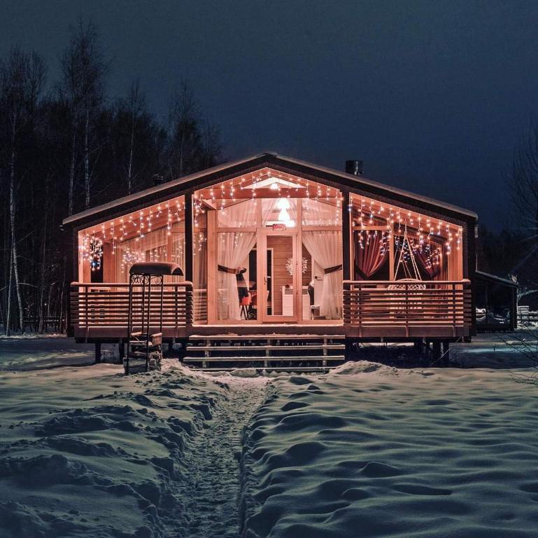 a house covered in christmas lights in the snow at Bohemian Homes - Buddha in Horní Podluží