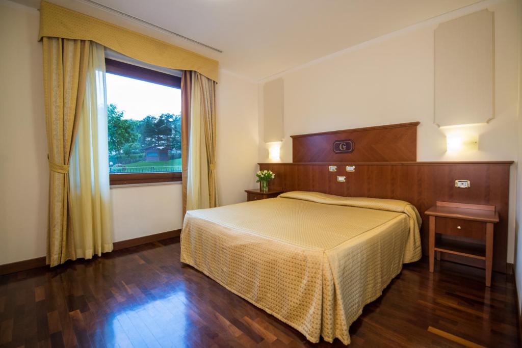 Postel nebo postele na pokoji v ubytování Hotel Le Grotte