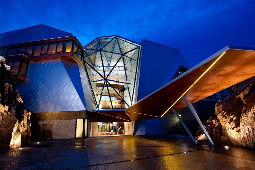 un edificio con fachada de cristal por la noche en Sparkling Hill Resort and Spa - Adults-Only Resort, en Vernon