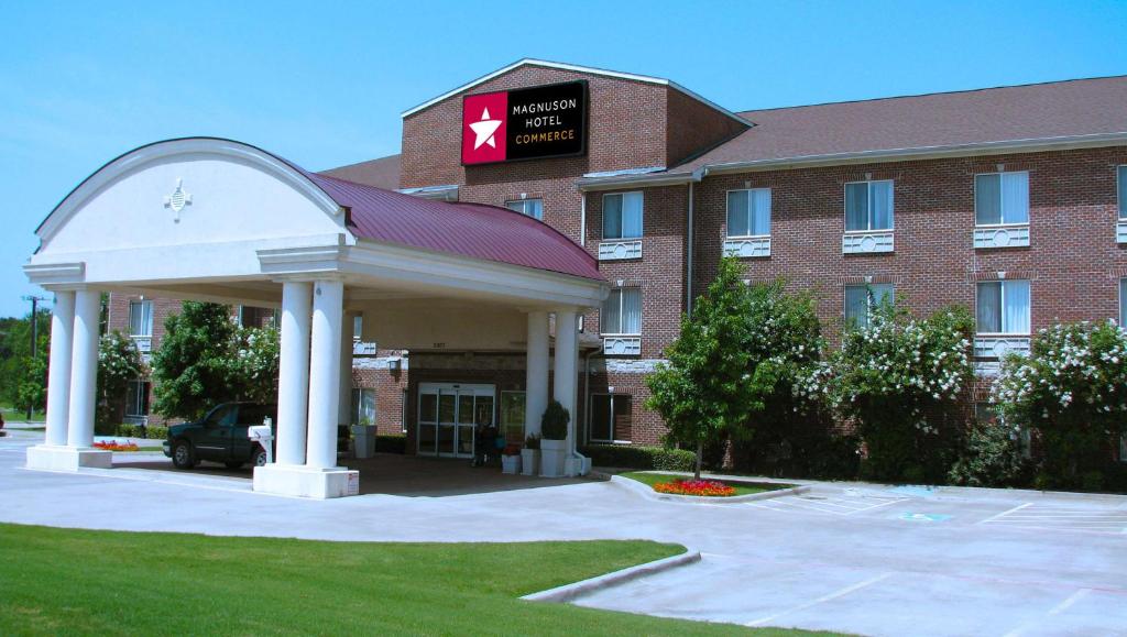 a hotel with a gazebo in front of a building at Magnuson Hotel Commerce in Commerce