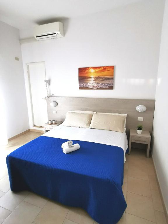 Łóżko lub łóżka w pokoju w obiekcie Hotel Bellini