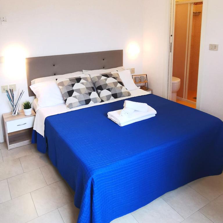 Łóżko lub łóżka w pokoju w obiekcie Hotel Bellini