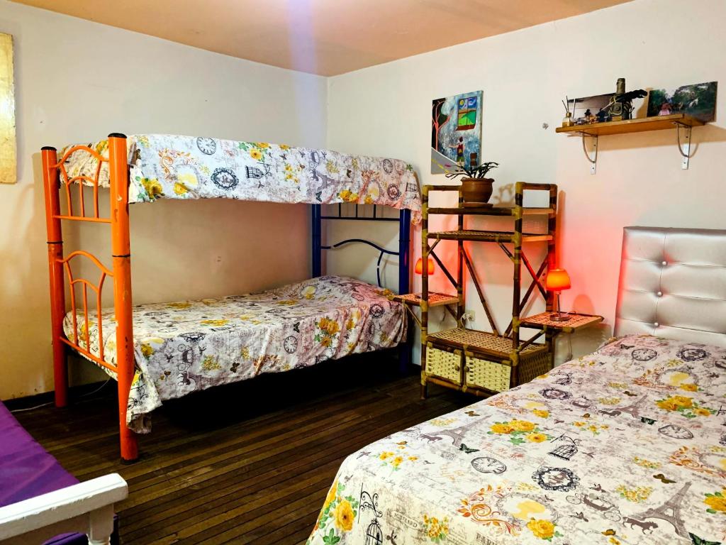 a bedroom with two bunk beds and a table at Casa artistica CANDELARIA in Bogotá