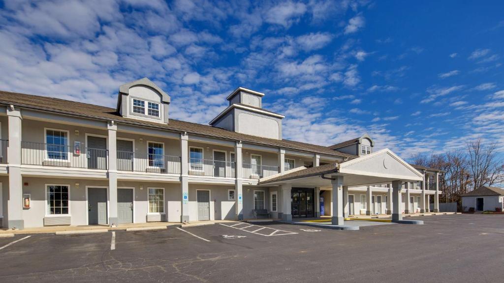 a large building with a parking lot in front of it at SureStay Plus Hotel by Best Western Asheboro in Asheboro