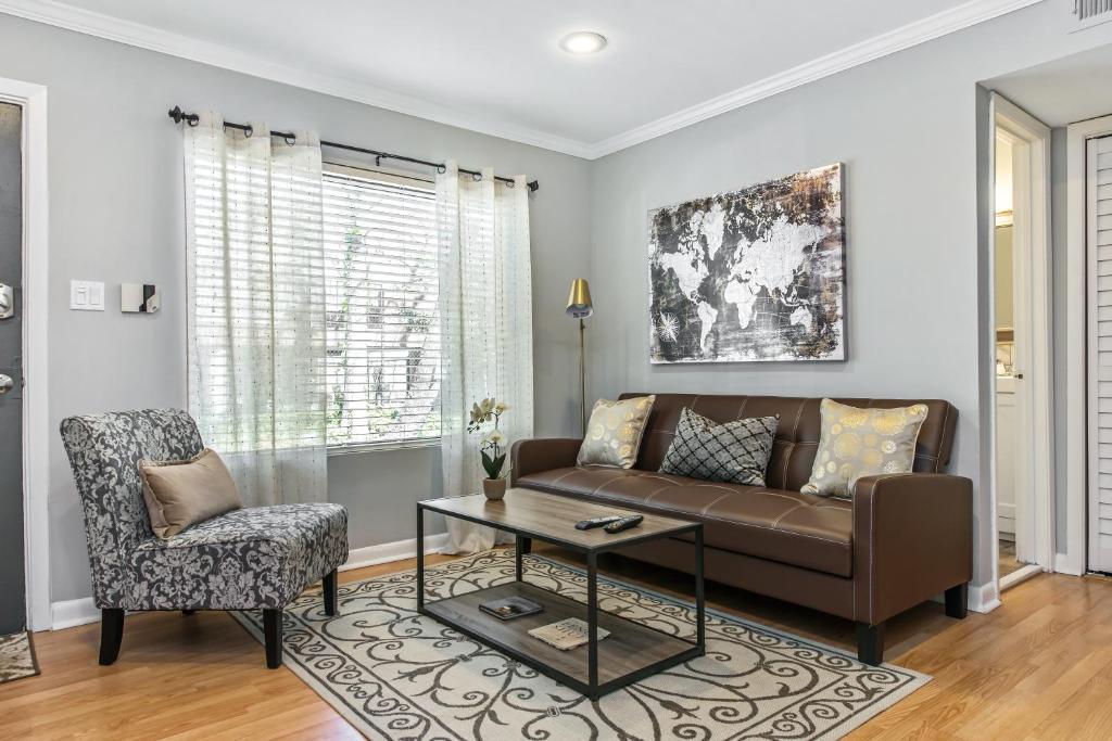 a living room with a couch and a chair at The Best Midtown Location by Piedmont Park in Atlanta