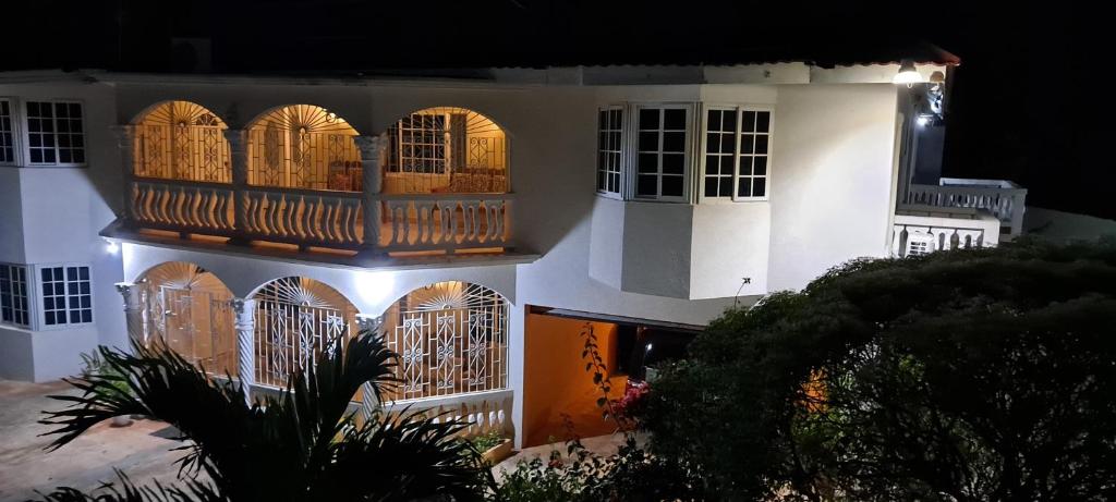 a white building with a balcony on the side of it at Eve's Rockaway Villa in Alligator Pond Village
