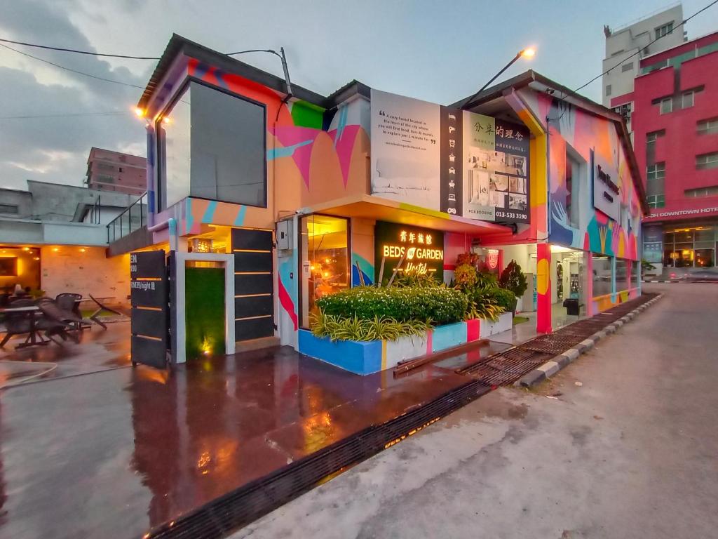 a building with colorful paint on it on a street at Beds In Garden Hostel in Ipoh