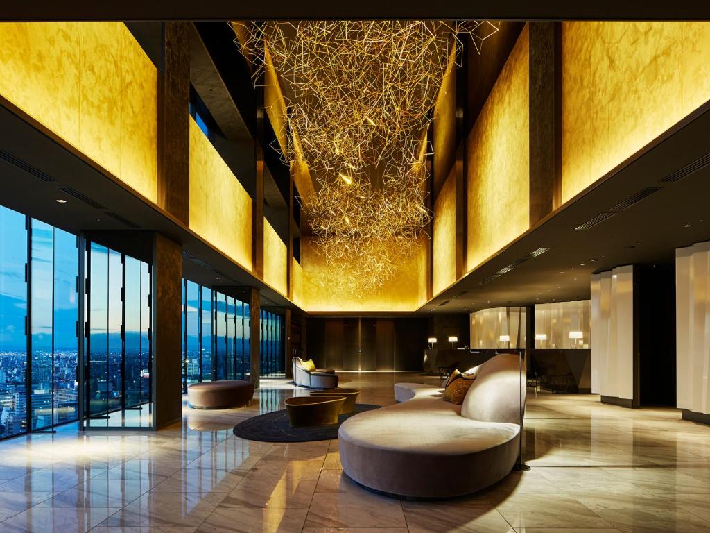 a lobby with couches and chairs in a building at Mitsui Garden Hotel Nagoya Premier in Nagoya