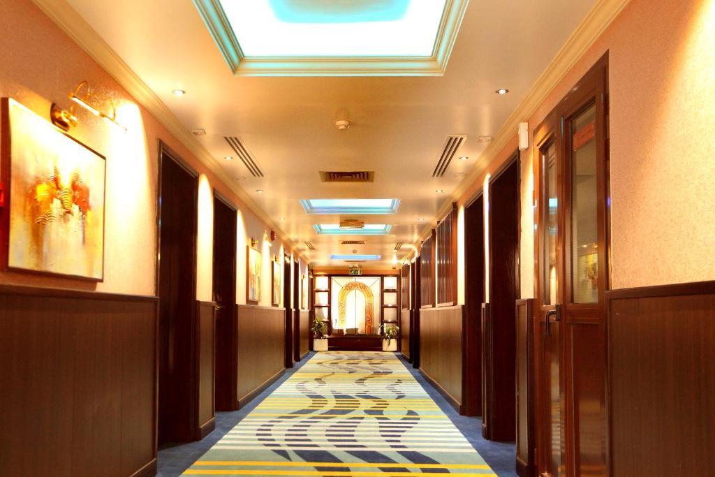 a hallway with a tile floor in a building at Gulf Inn Hotel Deira Formerly City Star Hotel in Dubai
