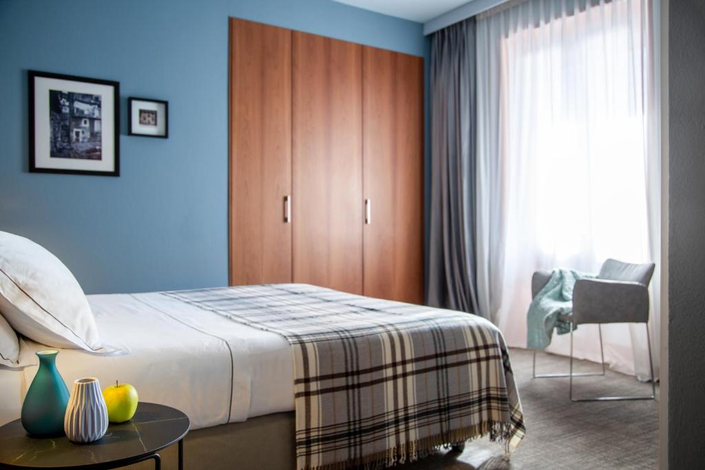 a bedroom with a bed and a table with fruit on it at Hotel Tremoggia in Chiesa in Valmalenco
