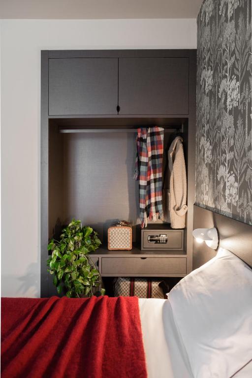 a bedroom with a bed and a cabinet and a bed sidx sidx sidx at Hotel Tremoggia in Chiesa in Valmalenco