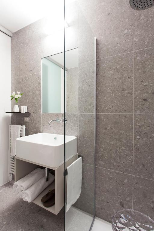 a bathroom with a sink and a glass shower at Hotel Tremoggia in Chiesa in Valmalenco