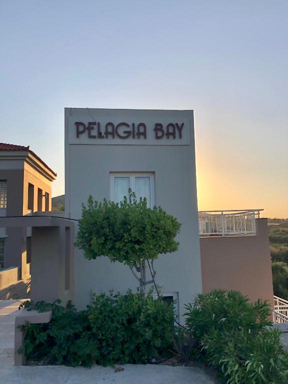 a building with a sign that reads pelican bay at Pelagia Bay Hotel in Agia Pelagia