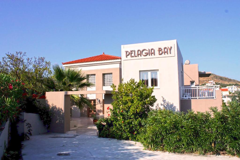 a building with a sign for a pizza shop at Pelagia Bay Hotel in Agia Pelagia