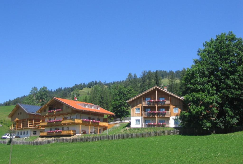 a group of buildings in a field with trees at Residence Rosarela in Badia